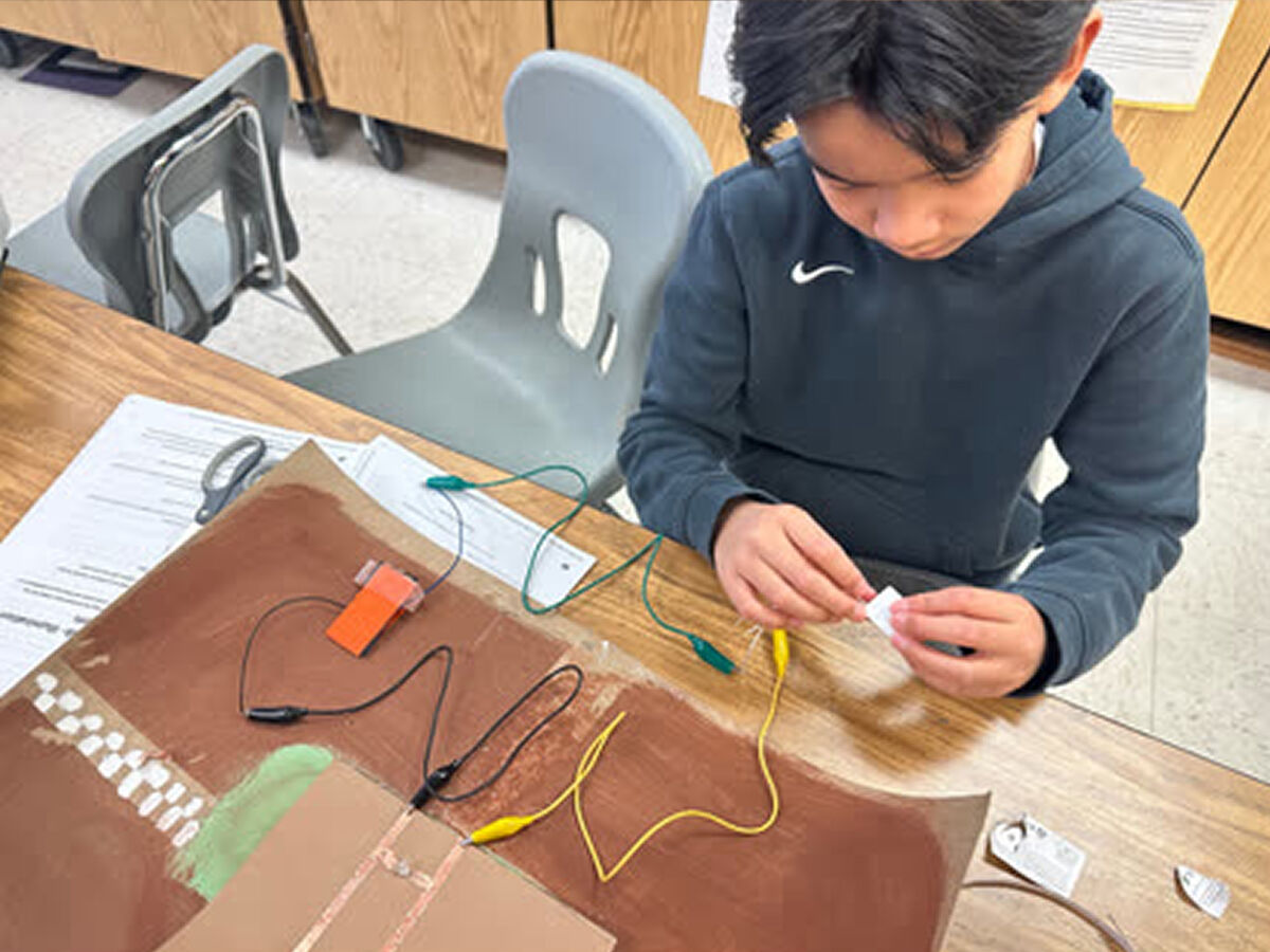 Student wiring a circuit board project