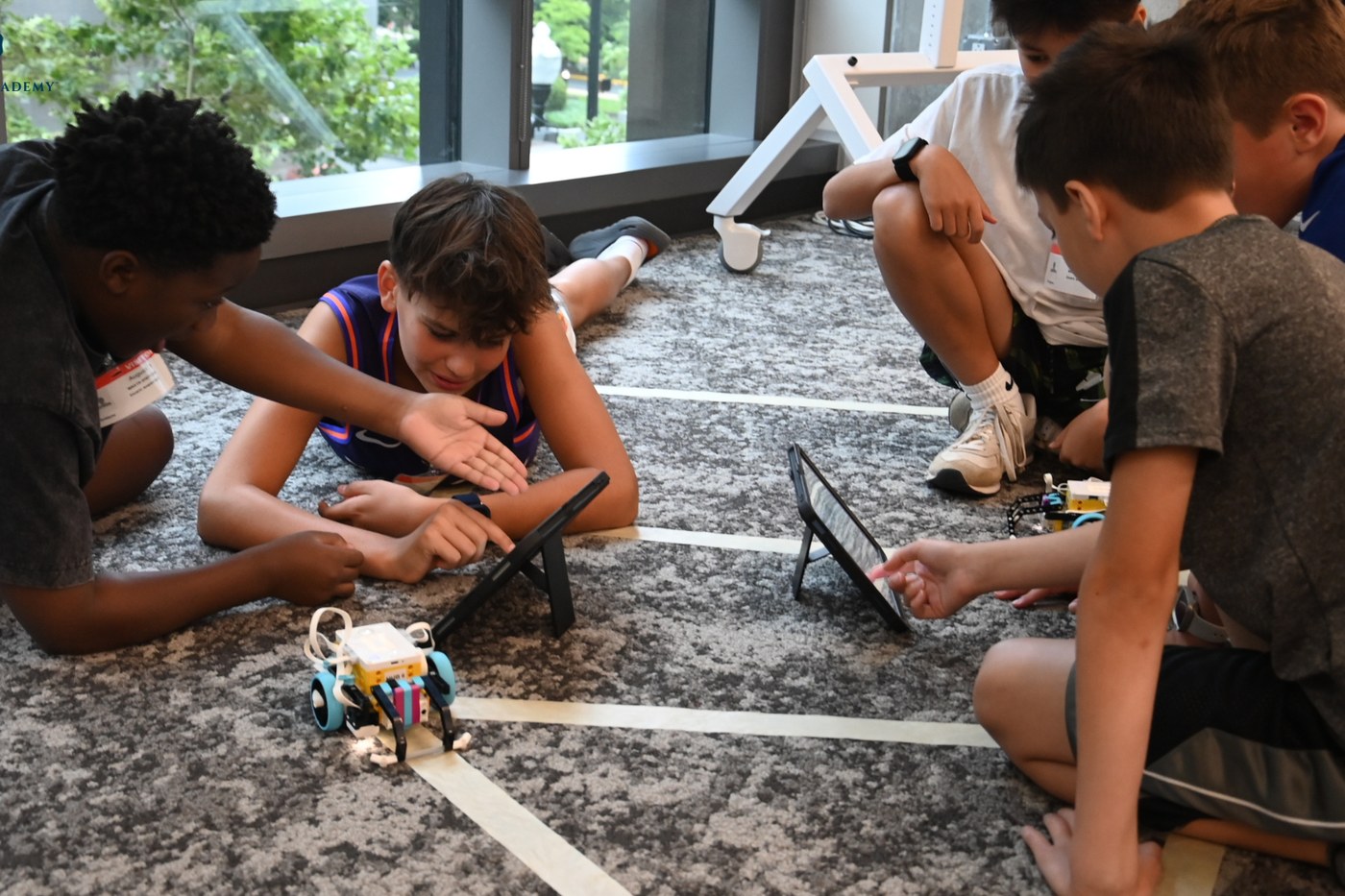 Students testing a robot on a floor course during an Orblynx after-school session